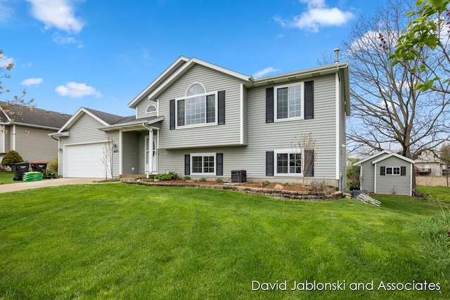 split level home with driveway, central AC unit, a storage unit, an attached garage, and a front lawn