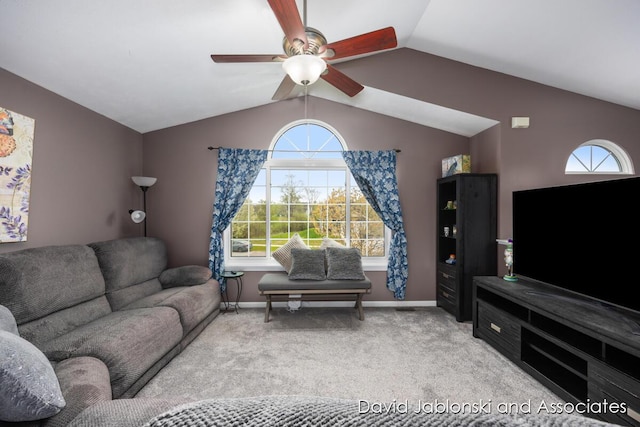 carpeted living area with baseboards, a ceiling fan, and vaulted ceiling