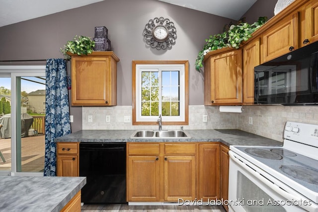 kitchen with a sink, a healthy amount of sunlight, black appliances, and lofted ceiling