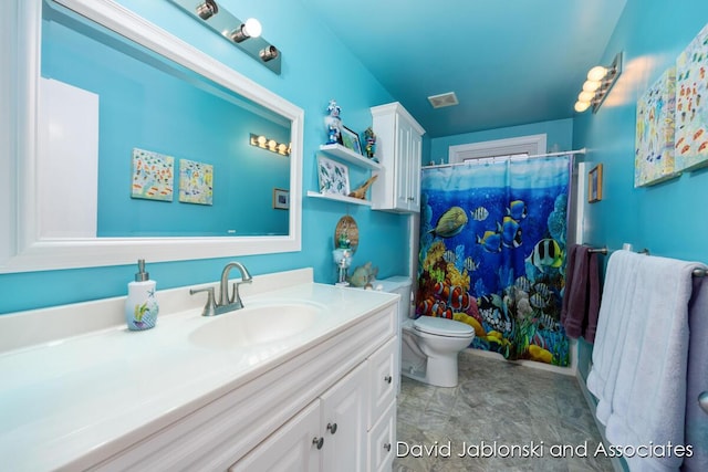 full bathroom with vanity, toilet, and visible vents