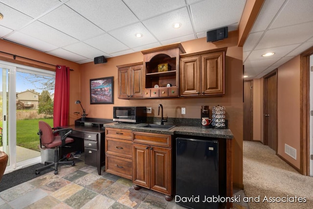 bar featuring fridge, a sink, a paneled ceiling, recessed lighting, and visible vents