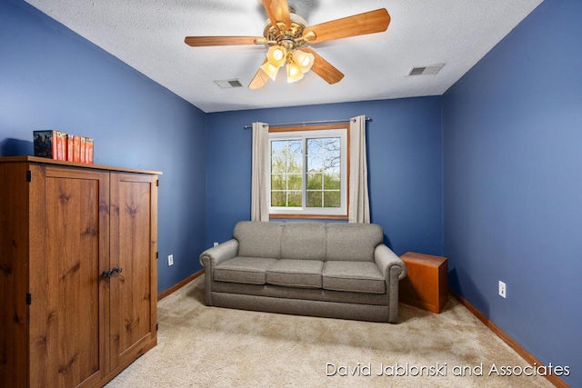 sitting room featuring baseboards, carpet, a ceiling fan, and visible vents