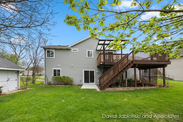 back of property with a lawn, a deck, and stairway