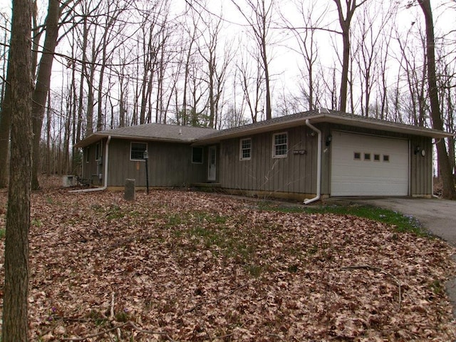 ranch-style house featuring a garage, board and batten siding, and driveway