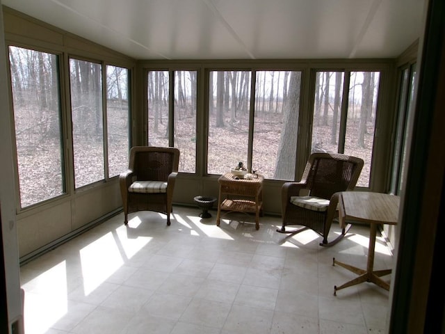 sunroom featuring a wealth of natural light and lofted ceiling