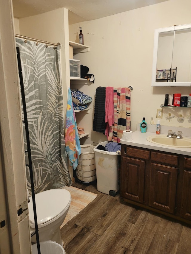 full bath with vanity, wood finished floors, toilet, and curtained shower