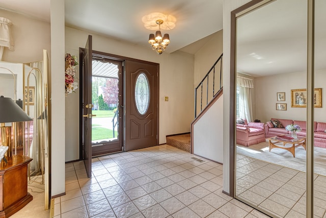 1471 Ledgewood Dr, Canton, MI 48188 - foyer with a chandelier, light tile patterned floors, and stairway