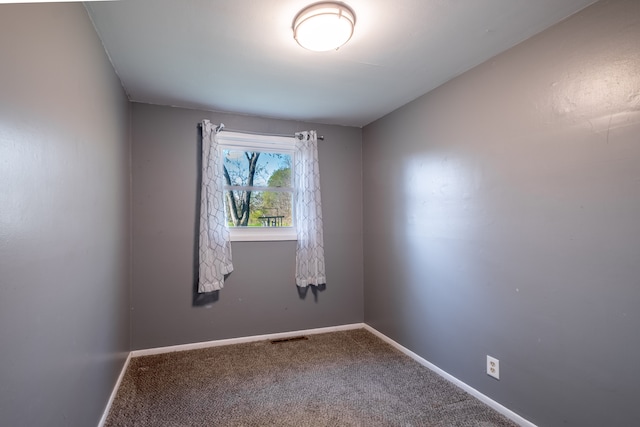 unfurnished room featuring carpet floors and baseboards