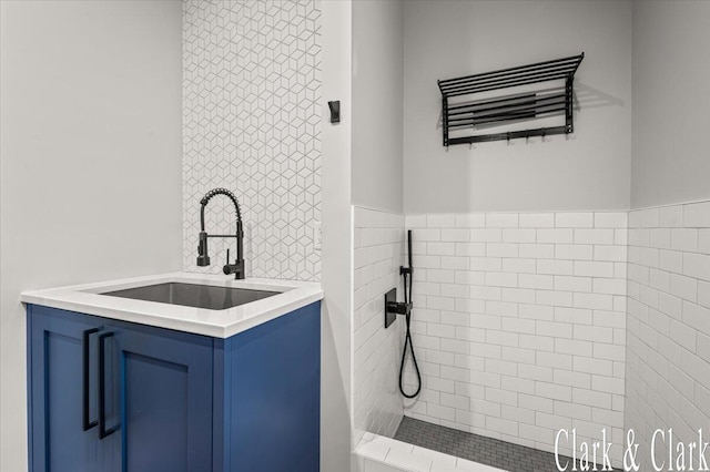 full bathroom featuring vanity and a tile shower