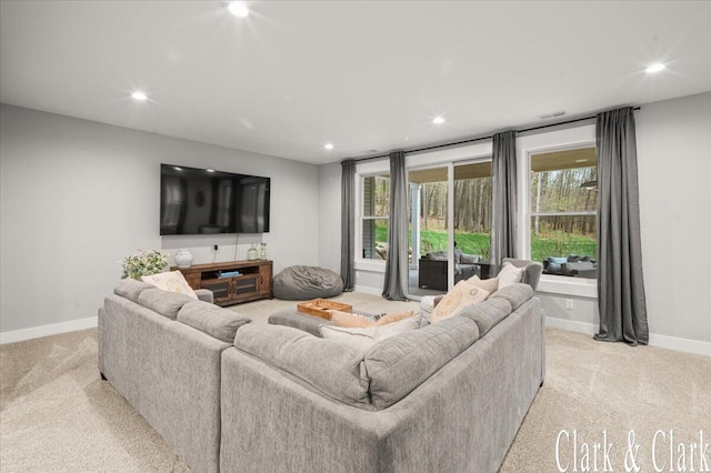 living area with recessed lighting, baseboards, and light carpet