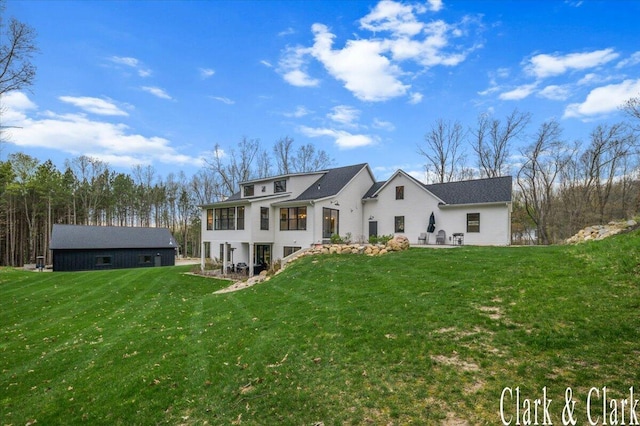 rear view of house with a yard