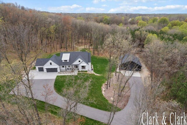 birds eye view of property with a forest view
