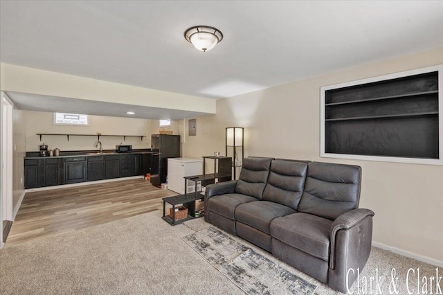 living room featuring baseboards and light carpet