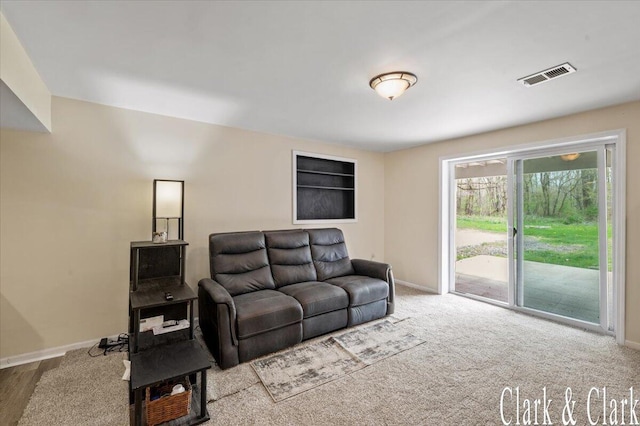 living area featuring baseboards and visible vents