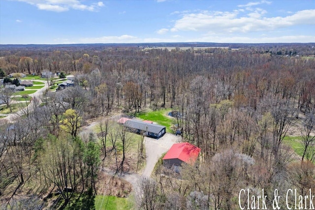 birds eye view of property featuring a view of trees