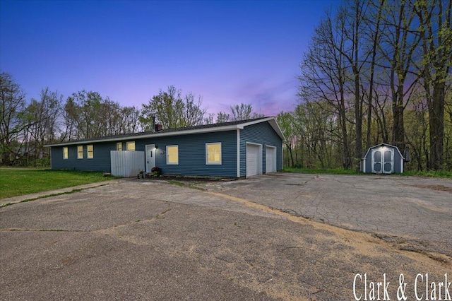 ranch-style house with a detached garage, an outbuilding, and a storage unit