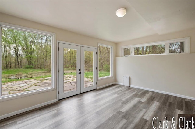 interior space featuring baseboards, french doors, and wood finished floors