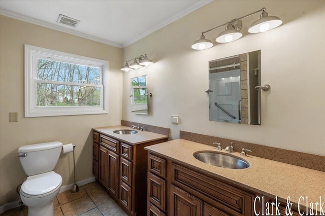 bathroom featuring visible vents, a sink, a shower with shower door, and toilet