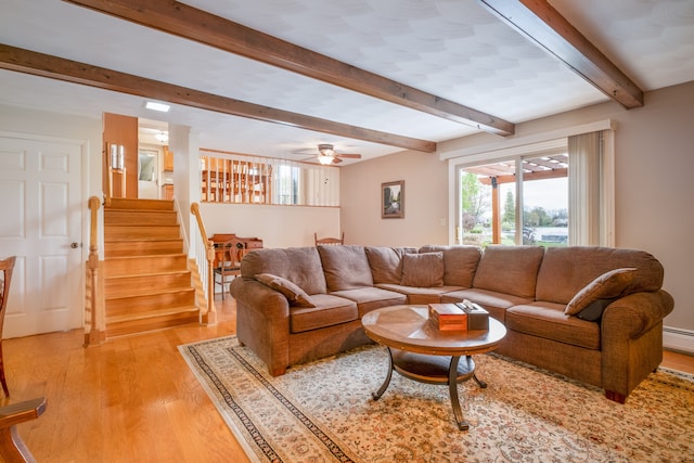 9145 Sandy Ridge Dr, White Lake, MI 48386 - living room featuring stairway, light wood-style flooring, a ceiling fan, and beam ceiling