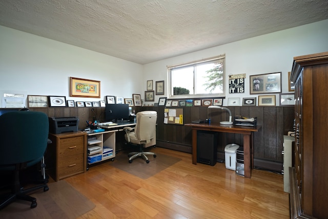 9145 Sandy Ridge Dr, White Lake, MI 48386 - office space featuring a wainscoted wall, baseboard heating, light wood-style flooring, and a textured ceiling