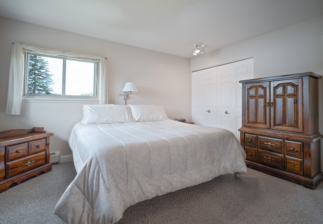 9145 Sandy Ridge Dr, White Lake, MI 48386 - bedroom with a baseboard heating unit, baseboards, a closet, and carpet