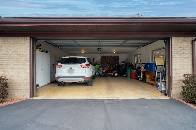 9145 Sandy Ridge Dr, White Lake, MI 48386 - garage featuring aphalt driveway and a garage door opener
