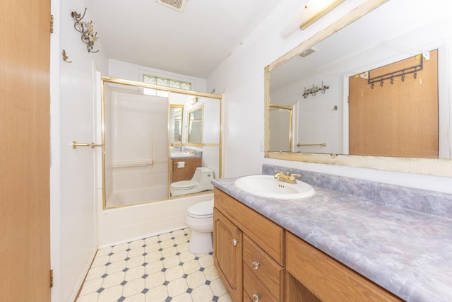 bathroom with toilet, tile patterned floors, vanity, and combined bath / shower with glass door