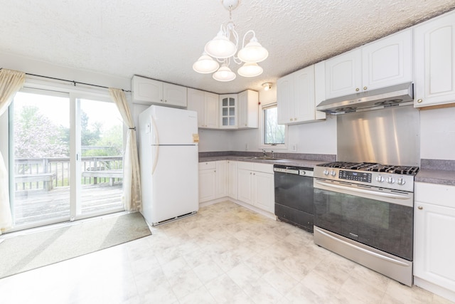 kitchen with a sink, stainless steel gas range oven, freestanding refrigerator, dishwasher, and under cabinet range hood