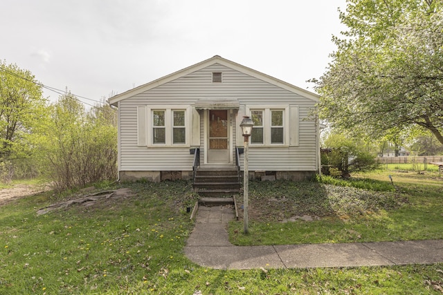 view of front of home featuring fence, a front yard, and entry steps