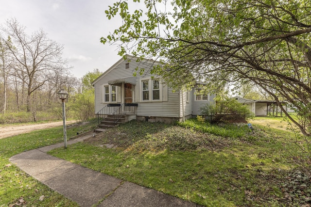 bungalow-style home featuring a front lawn
