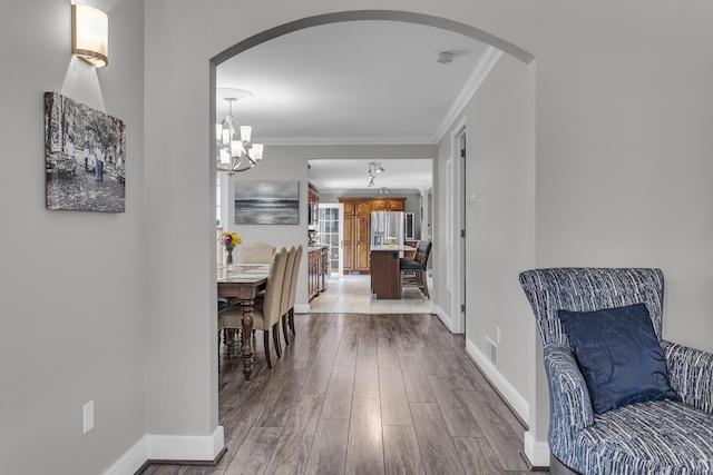 37 N Monroe St, Coldwater, MI 49036 - interior space featuring arched walkways, ornamental molding, wood finished floors, and a notable chandelier