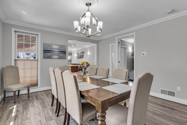 37 N Monroe St, Coldwater, MI 49036 - dining space with baseboards, visible vents, wood finished floors, and a chandelier