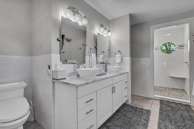 37 N Monroe St, Coldwater, MI 49036 - full bathroom featuring a sink, tile walls, toilet, and tiled shower
