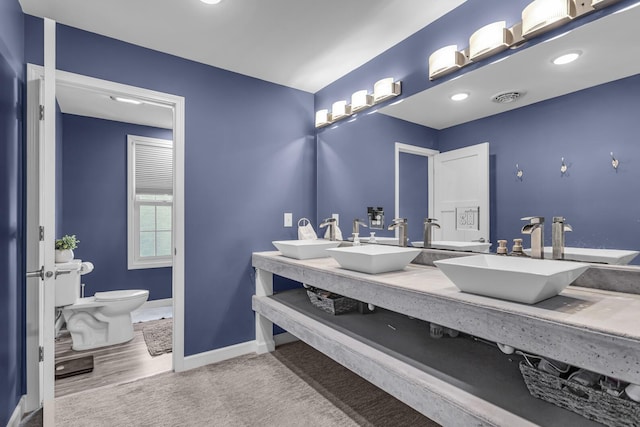 37 N Monroe St, Coldwater, MI 49036 - full bath featuring baseboards, a sink, visible vents, and toilet