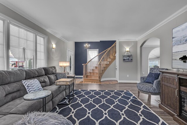 37 N Monroe St, Coldwater, MI 49036 - living room featuring wood finished floors, baseboards, a notable chandelier, ornamental molding, and stairs