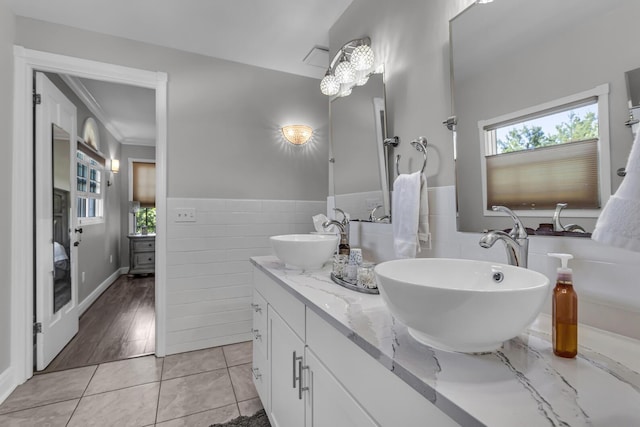 37 N Monroe St, Coldwater, MI 49036 - full bath featuring a sink, tile walls, and a healthy amount of sunlight