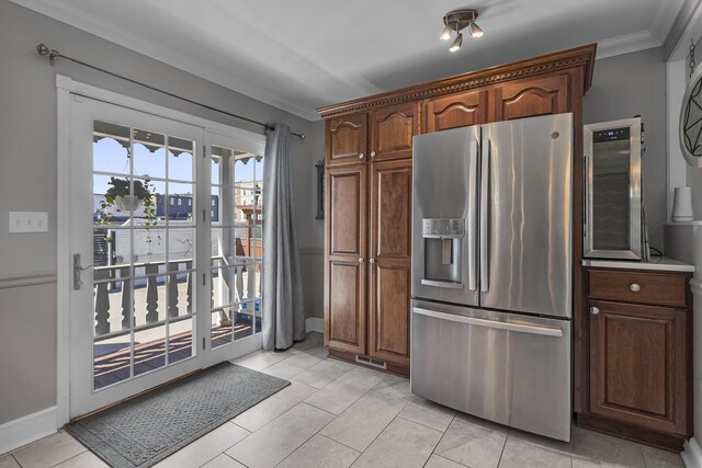 37 N Monroe St, Coldwater, MI 49036 - kitchen featuring crown molding, stainless steel fridge with ice dispenser, baseboards, and light tile patterned flooring