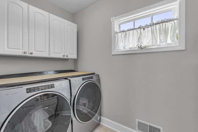 37 N Monroe St, Coldwater, MI 49036 - clothes washing area featuring independent washer and dryer, visible vents, cabinet space, baseboards, and light tile patterned flooring