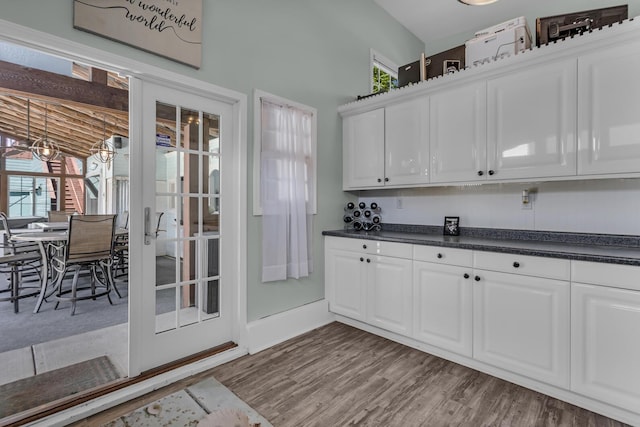 37 N Monroe St, Coldwater, MI 49036 - kitchen with dark countertops, plenty of natural light, white cabinetry, and wood finished floors