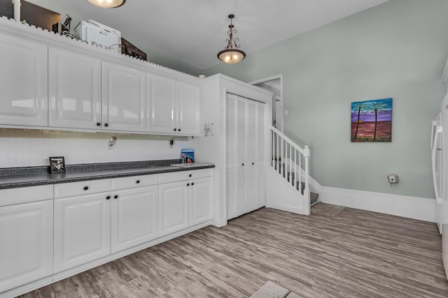 37 N Monroe St, Coldwater, MI 49036 - kitchen featuring light wood finished floors, dark countertops, and white cabinets