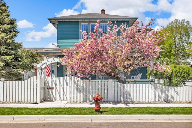 37 N Monroe St, Coldwater, MI 49036 - view of front facade with a gate, a fenced front yard, and a chimney