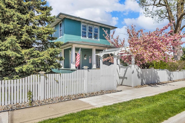 37 N Monroe St, Coldwater, MI 49036 - american foursquare style home with a porch and a fenced front yard