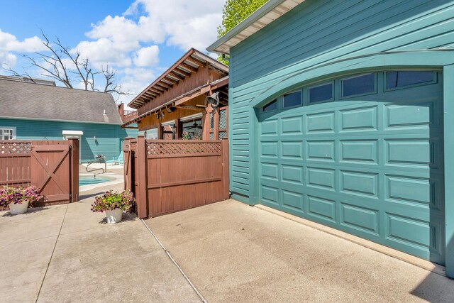 37 N Monroe St, Coldwater, MI 49036 - garage featuring driveway, fence, and a gate