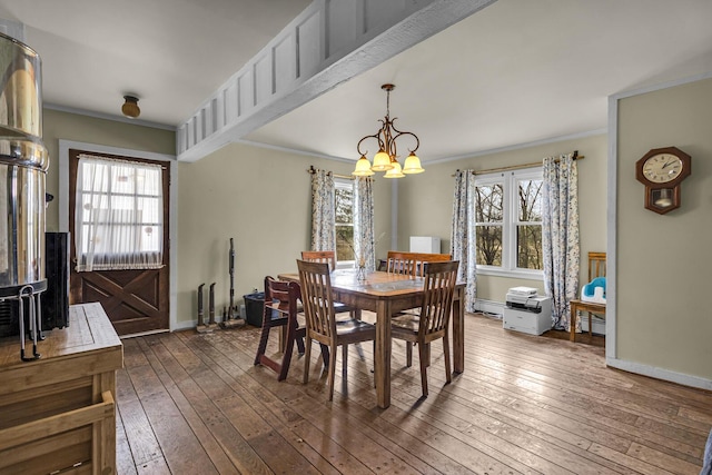 9875 Rountree Rd, Hanover, MI 49241 - dining room with a wealth of natural light, a notable chandelier, crown molding, and dark wood-type flooring