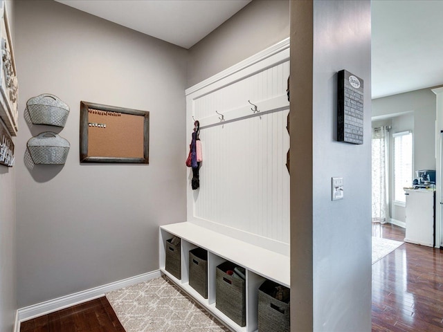 mudroom featuring wood finished floors and baseboards