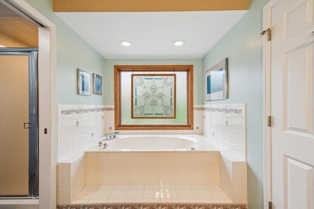 full bath with tile walls, a stall shower, a wainscoted wall, and a garden tub