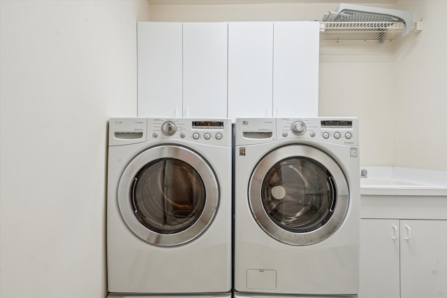 washroom with washer and dryer and cabinet space