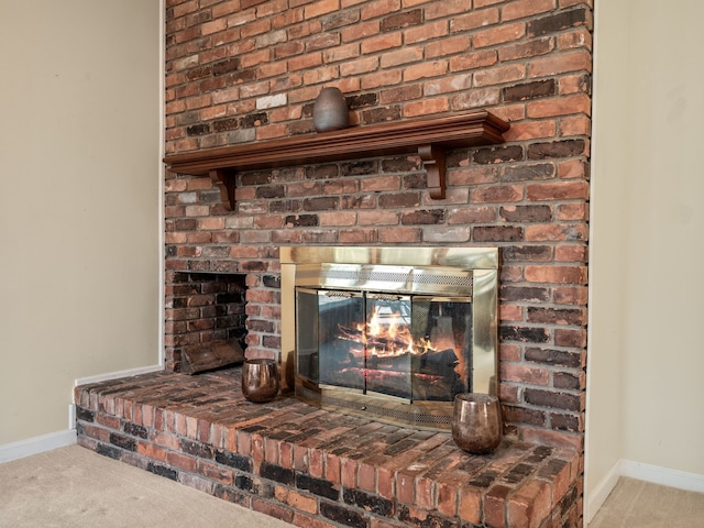 room details with carpet flooring, baseboards, and a brick fireplace