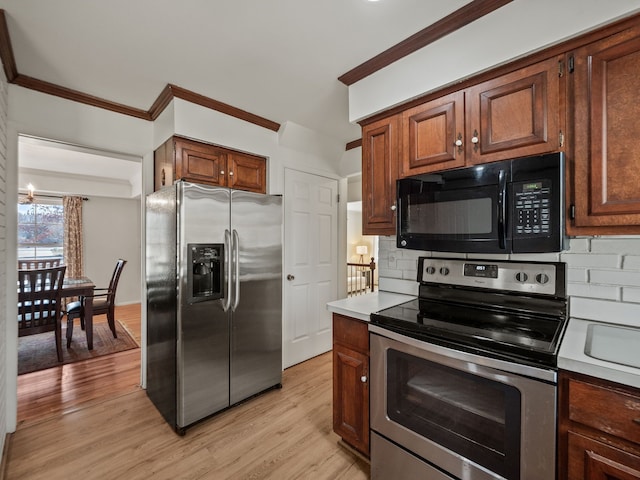 kitchen featuring stainless steel appliances, light wood-style flooring, ornamental molding, and backsplash