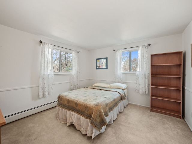 bedroom with multiple windows, carpet flooring, and baseboard heating